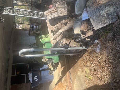 8 foot long tubular, steel welded log rack with wood